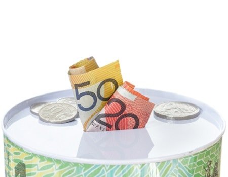 Austalian notes and coins on a money tin